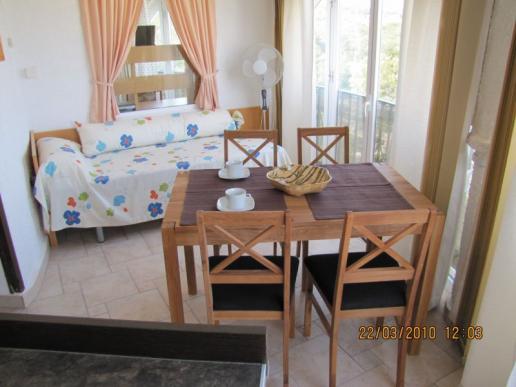 Küche mit Esstisch und Doppelbett in der unteren Etage